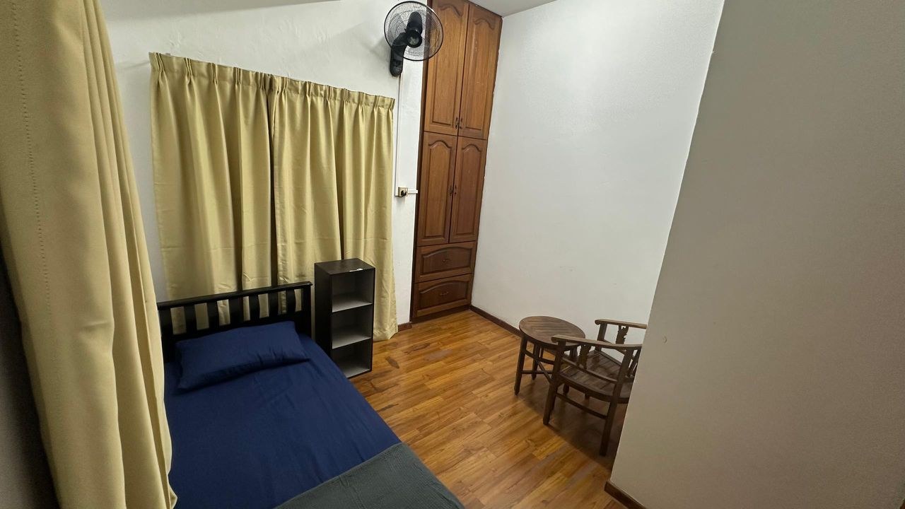 Single bedroom with seating and wardrobe