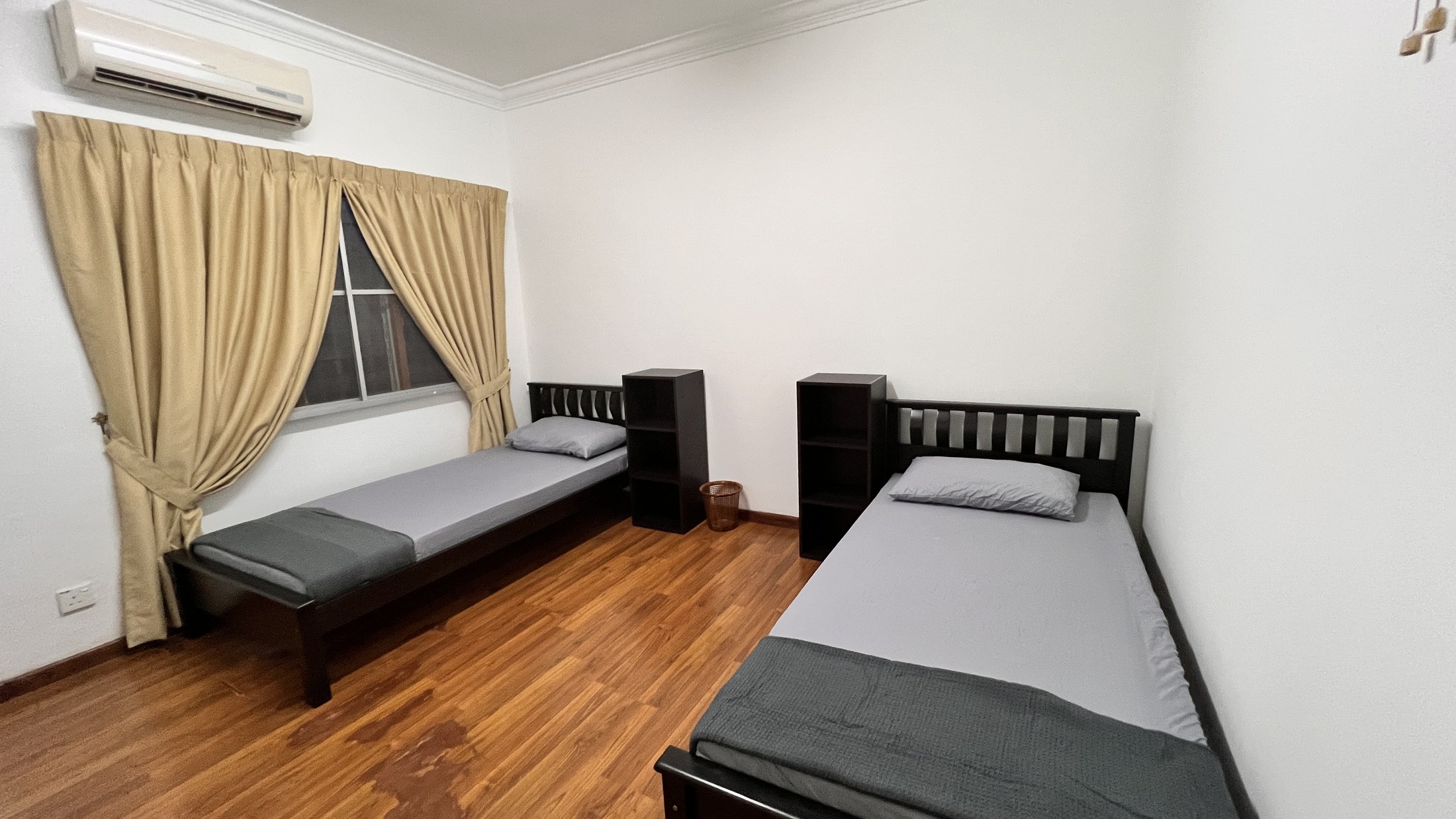 Twin bedroom with window and bedside shelving